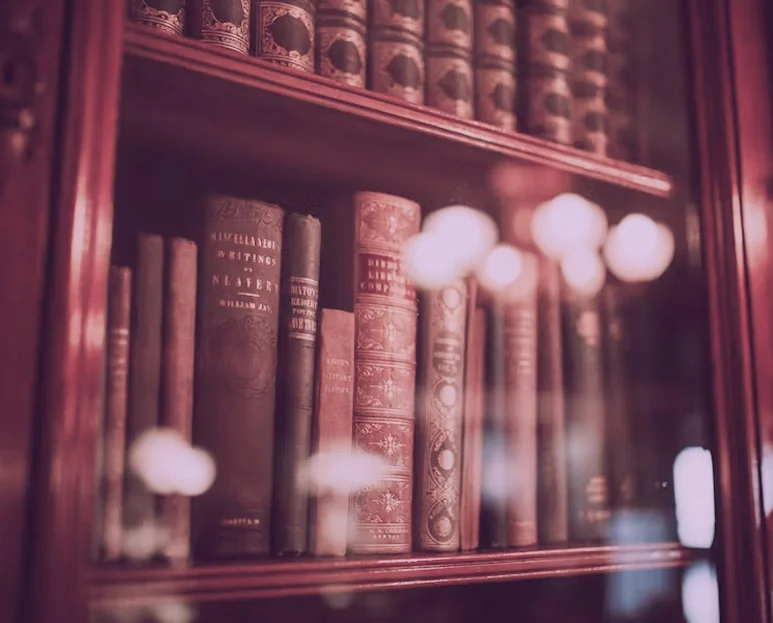 Antique books on a wooden bookshelf